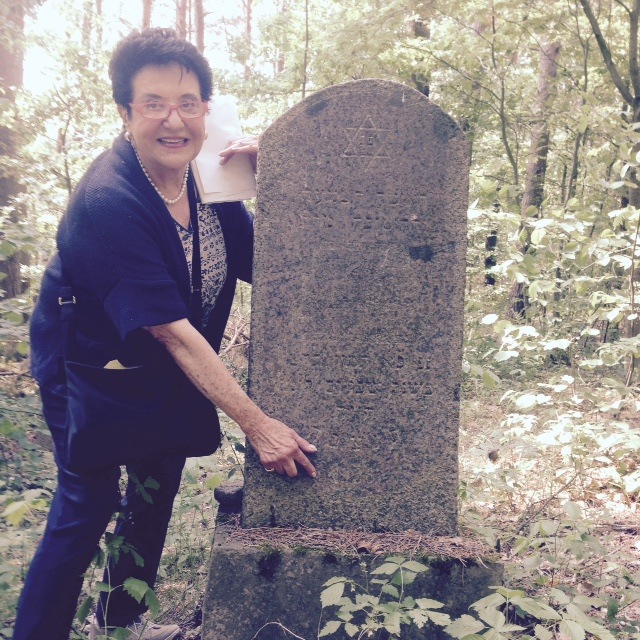 Barbara at the gravestone of her
                                grandmother Bella