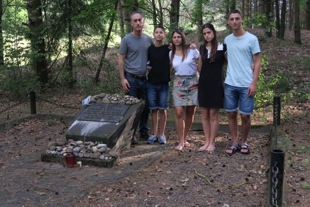 Israel Birenbaum and his family
                                  at the memorial at the site of the
                                  mass grave.