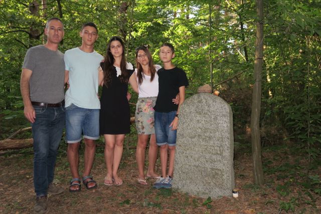 Israel Birenbaum and his family
                                  at the gravestone of his
                                  great-grandfather.