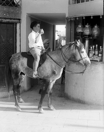 Farmer's Son Drinking at Kiosk